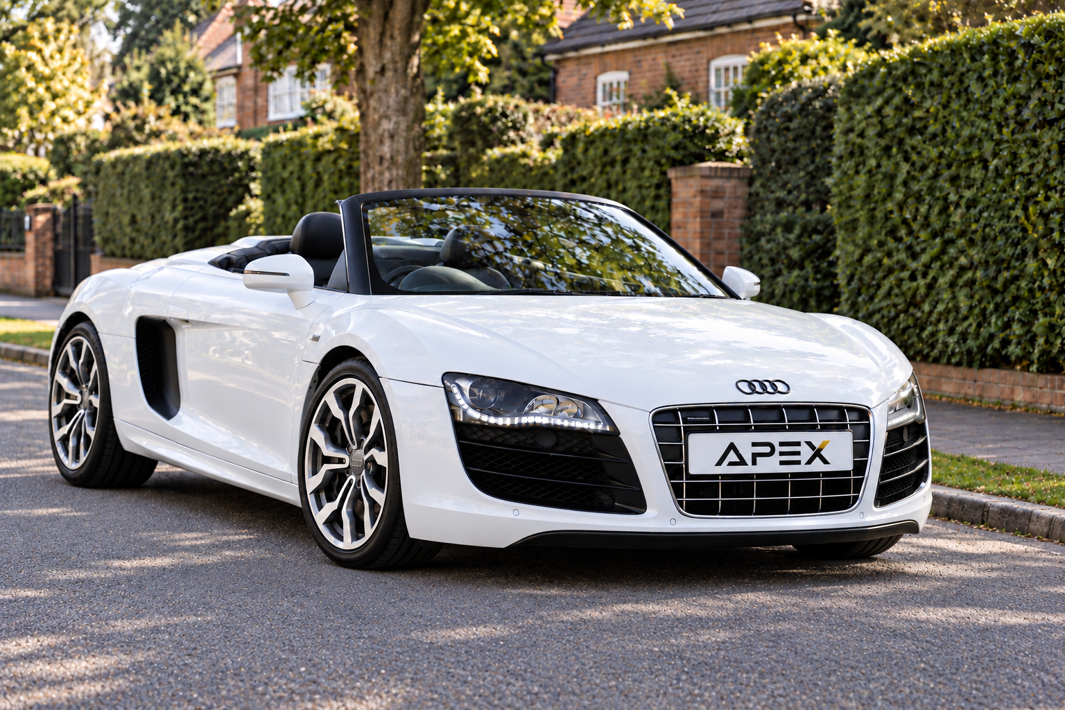Illustrative white Audi R8 Spyder with its roof down