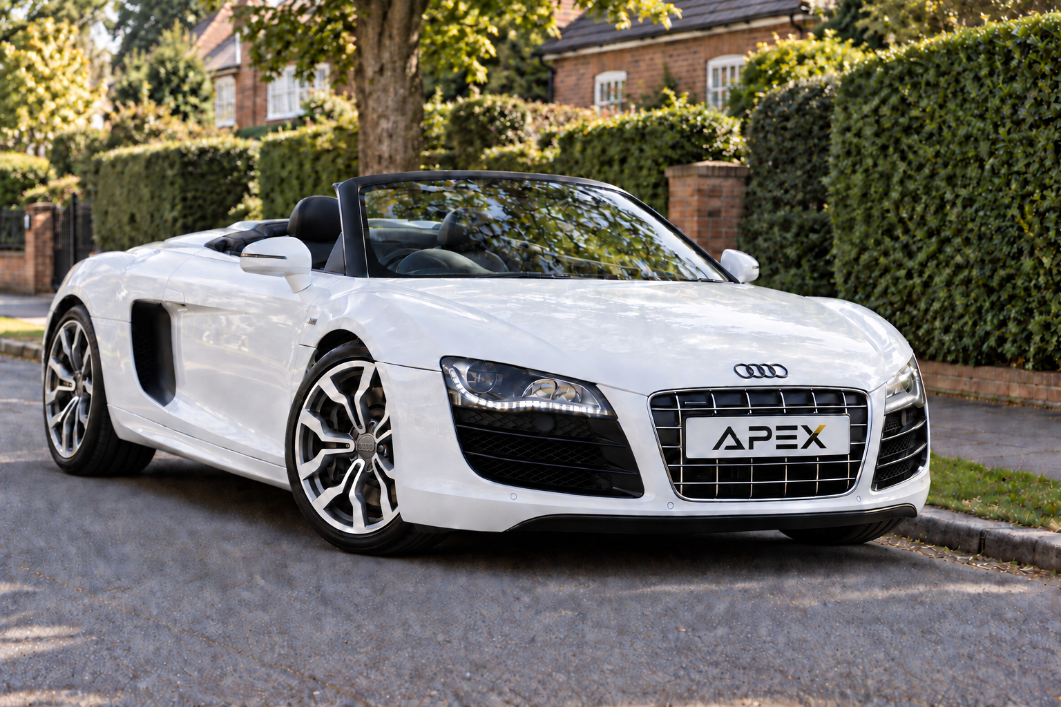Illustrative white Audi R8 Spyder with its roof down